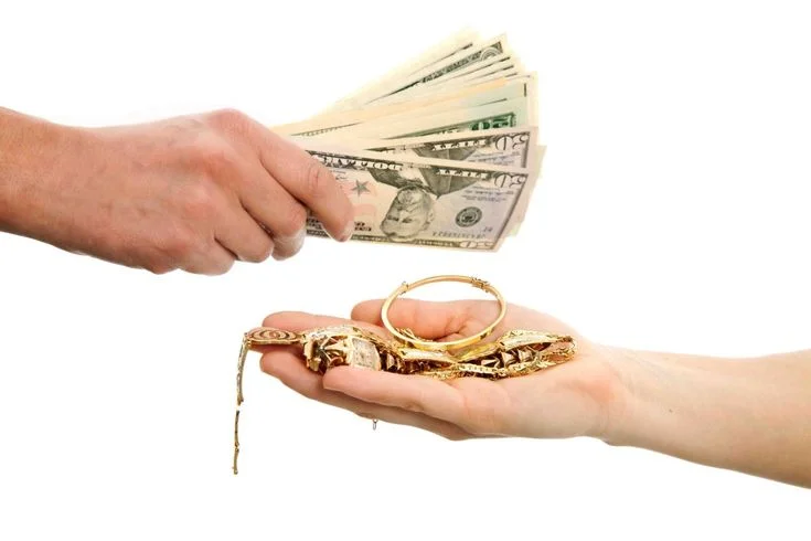 Cash being exchanged for gold jewelry