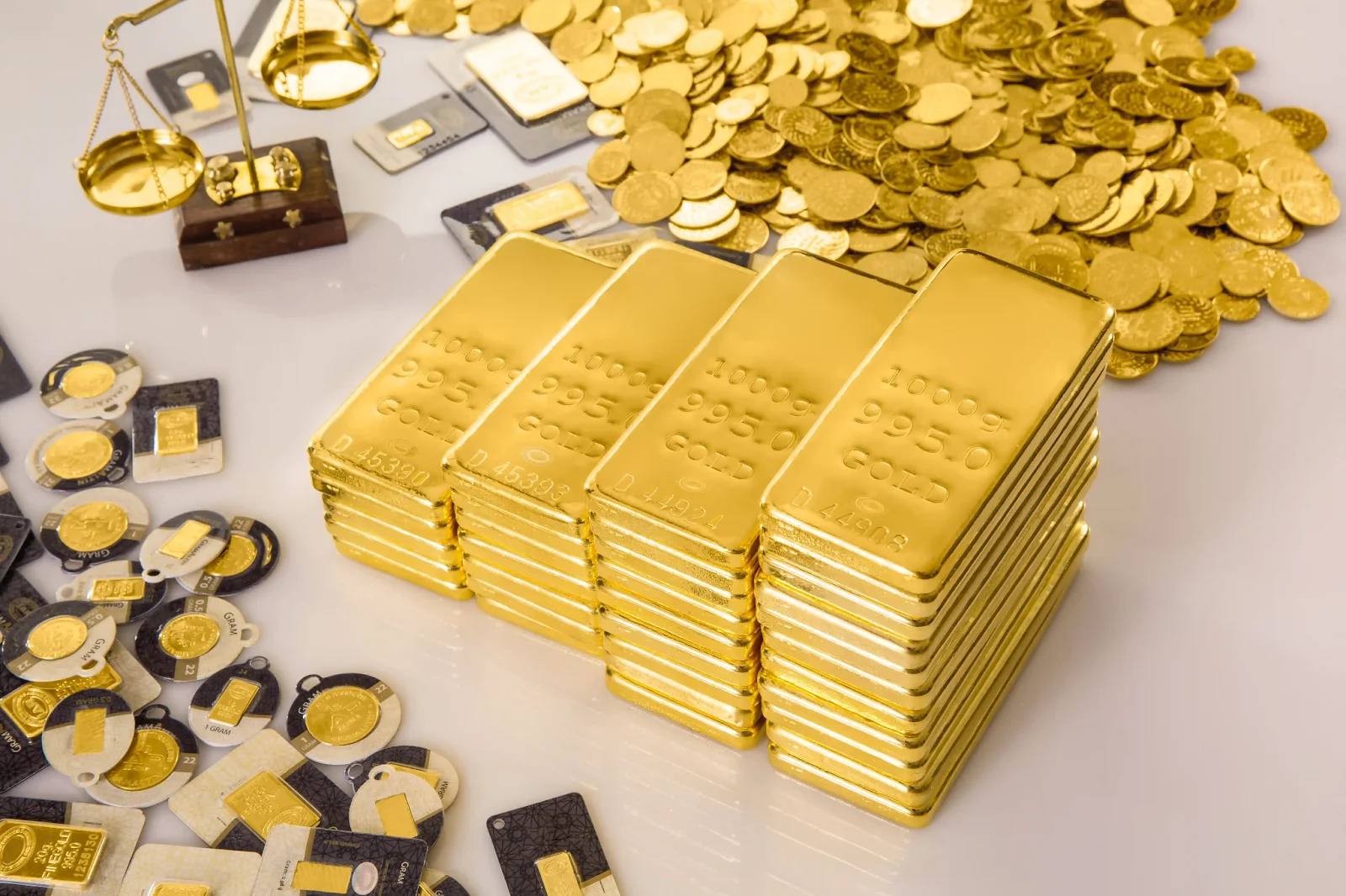Gold bars, coins, and valuation scale